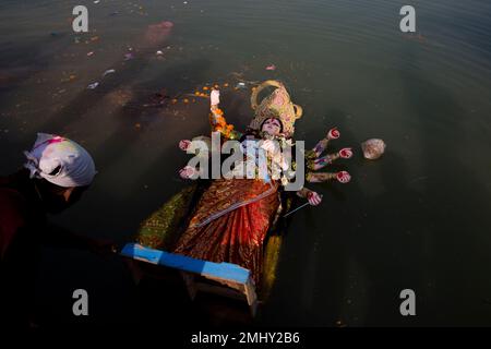 An idol of Hindu Goddess Durga floats in a makeshift pond after it was ...