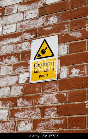 Anti climb paint sign on a brick wall in Norfolk Stock Photo