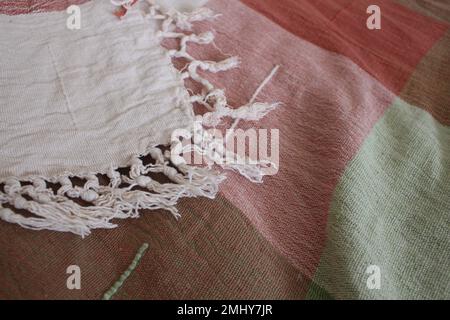 Comfortable warm cozy blanket with white tassels Stock Photo