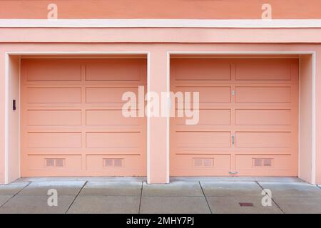 Two single car Garage Doors painted with pastel color. Stock Photo