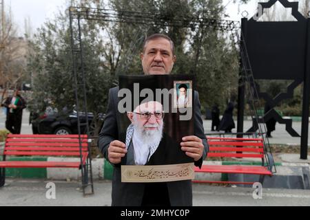 Tehran, Tehran, Iran. 27th Jan, 2023. An Iranian man holds a portrait of Iranian supreme leader Ayatollah Ali Khamenei during a protest against the burning of a Koran in Stockholm after performing Friday prayer at Imam Khomeini Mosque in Tehran, Iran, on January 27, 2023. Swedish-Danish far-right politician Rasmus Paludan set fire to a copy of the Muslim holy book in front of Turkey's embassy in the Swedish capital. Many Muslim countries have said they were outraged by the burning of the Koran, which Swedish Prime Minister Ulf Kristersson condemned as ''deeply disrespectful' (Credit Image: © C Stock Photo