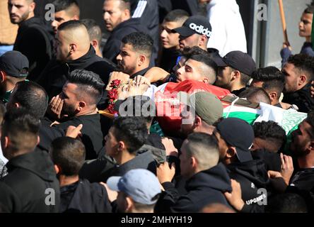 Al Ram, Palestine. 27th Jan, 2023. (EDITORS NOTE: Image depicts death)Mourners carry the body of Palestinian Youssef Yahya Abdel Karim Mohsen (22 years old), who was severely wounded by Israeli gunfire and lost his life in the hospital in the town of Al-Ram in East Jerusalem. Palestinian Youssef Yahya Abdel Karim Mohsen (22 years old) was severely wounded by Israeli gunfire and lost his life in the hospital in the town of Al-Ram in East Jerusalem. (Photo by Saeed Qaq/SOPA Images/Sipa USA) Credit: Sipa USA/Alamy Live News Stock Photo