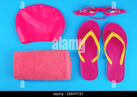 Flat lay composition with swimming accessories on light blue background Stock Photo