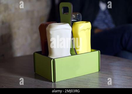 sauce dispenser, wooden saucer, ketchup mayonnaise mustard Stock Photo
