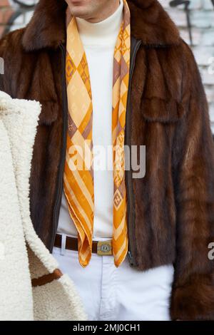 Man with Fendi coat with logos and woman with fur coat with yellow