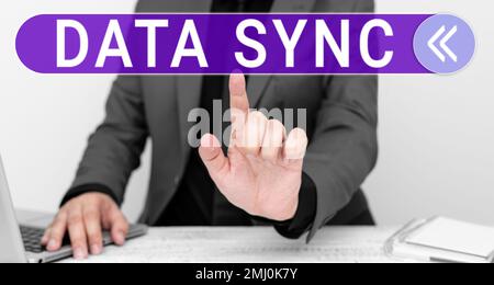 Hand writing sign Data Sync. Concept meaning data that is continuously generated by different sources Stock Photo