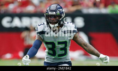 Seattle Seahawks free safety Tedric Thompson, lower left, intercepts a pass  intended for Los Angeles Rams tight end Gerald Everett, right, as outside  linebacker K.J. Wright (50) looks on, during the second