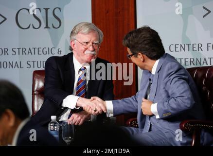 Former National security adviser John Bolton left shakes hands