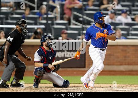 New York Mets shortstop Luis Guillorme (13) and Pete Alonso, right, tear  the jersey off teammat …