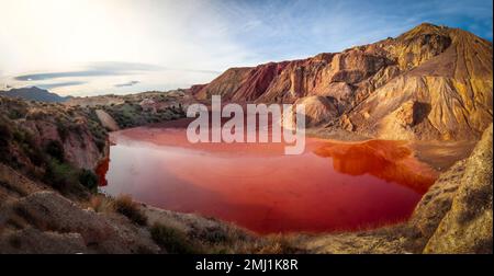 Panoramic view of an artificial lake in the mines of Mazarorn, Region of Murcia, Spain. Intense red in color due to the content of iron minerals Stock Photo