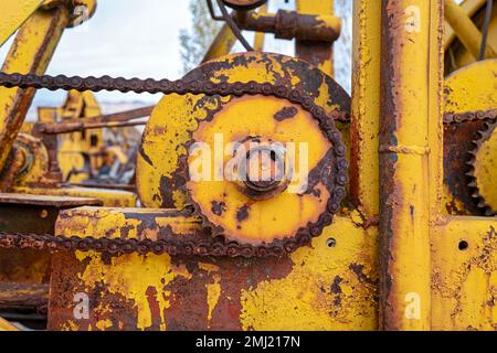 Corroded chain on a rusty gear wheel of an antique machine Stock Photo