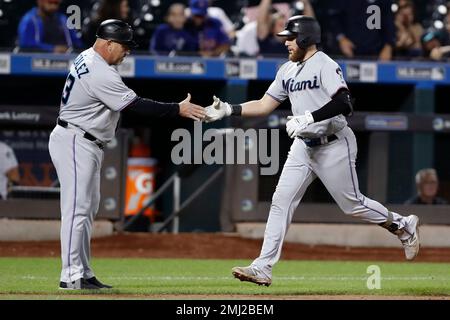 Miami Marlins third base coach Lenny Harris congratulates Ichiro