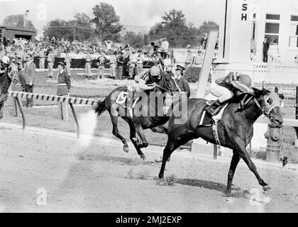 Cannonade, right, with jockey Angel Cordero aboard, crosses the