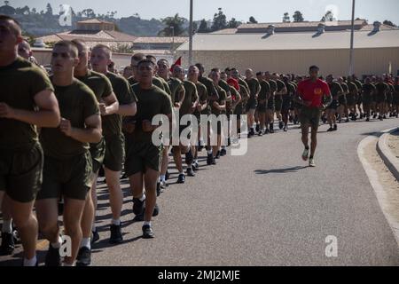New U.S. Marines with Alpha Company, 1st Recruit Training Battalion, run in formation during a motivational run at Marine Corps Recruit Depot San Diego, Aug. 25, 2022. The motivational run was the last physical fitness event conducted in recruit training. Stock Photo