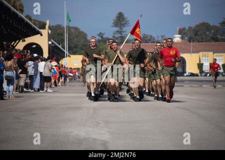 New U.S. Marines with Alpha Company, 1st Recruit Training Battalion, run in formation during a motivational run at Marine Corps Recruit Depot San Diego, Aug. 25, 2022. The motivational run was the last physical fitness event conducted in recruit training. Stock Photo
