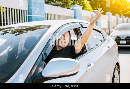 Angry driver yelling at another driver. Driver man yelling at driver while driving, Impatient driver yelling. Shouting impatient driver concept Stock Photo