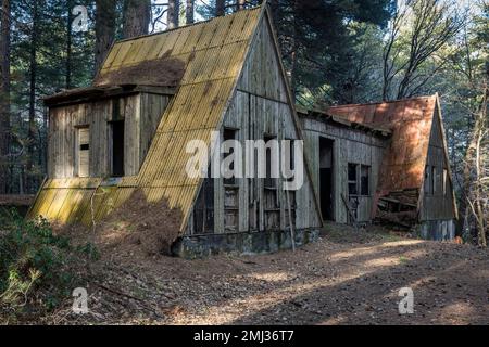 An empty and derelict hut in an old abandoned ski resort in the woods on Mount Etna, Sicily, Italy Stock Photo