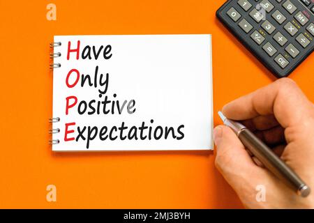 HOPE have only positive expectations symbol. Concept words HOPE have only positive expectations on note on beautiful orange background. Business HOPE Stock Photo