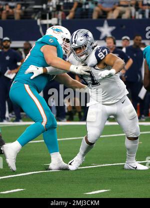 Miami Dolphins guard Michael Deiter (63) carries a football as he warms up  on the field before an NFL football game against the Buffalo Bills, Sunday,  Sept. 19, 2021, in Miami Gardens