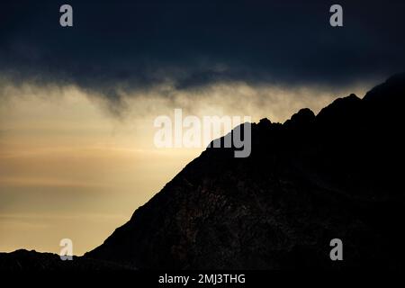 Dramatic clouds over Engadine mountains at blue hour, St Moritz, Engadine, Grisons, Switzerland Stock Photo