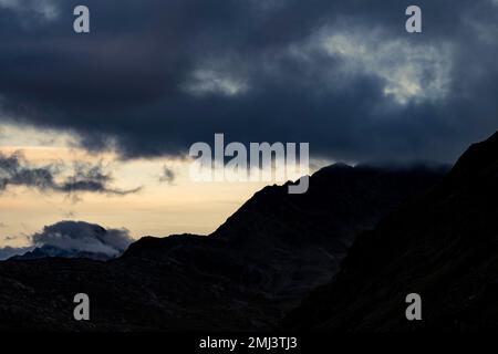 Dramatic clouds over Engadine mountains at blue hour, St Moritz, Engadine, Grisons, Switzerland Stock Photo