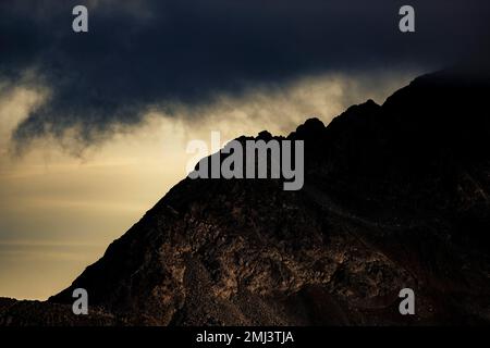 Dramatic clouds over Engadine mountains at blue hour, St Moritz, Engadine, Grisons, Switzerland Stock Photo