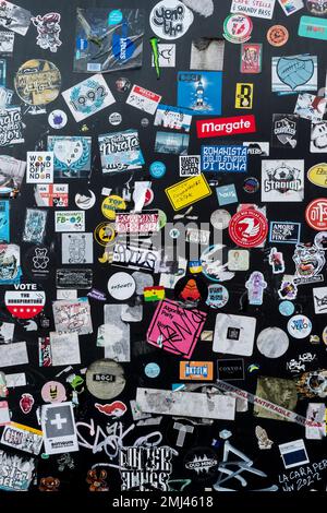 Stickers fly posted on a wall in Liverpool.  Many for independent bands. Stock Photo
