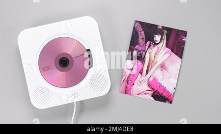 BlackPink BORN PINK 2nd Album collectible photo card with Lisa on grey. Pink music CD in player. South Korean girl group BlackPink. Space for text Stock Photo