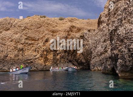 BISEVO ISLAND, CROATIA, EUROPE - Tourists in boats at entrance to Blue Cave, near island of Vis, in Adriatic Sea. Stock Photo