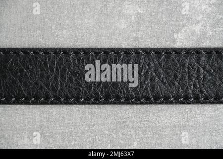 Black leather belt gray concrete background Stock Photo