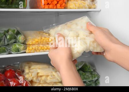 Containers and plastic bags with frozen vegetables in refrigerator Stock  Photo - Alamy