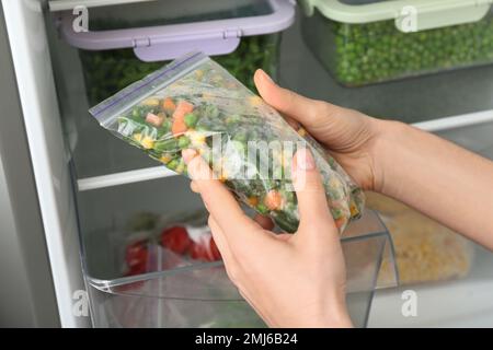 Containers and plastic bags with frozen vegetables in refrigerator Stock  Photo - Alamy