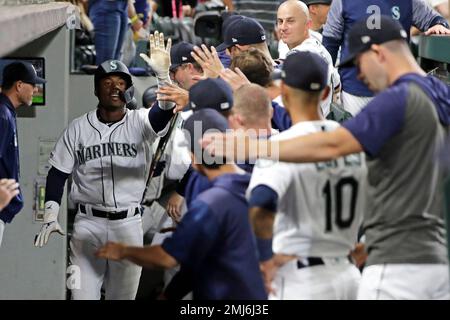 Seattle Mariners' Kyle Lewis, left, is greeted by Taylor Trammell