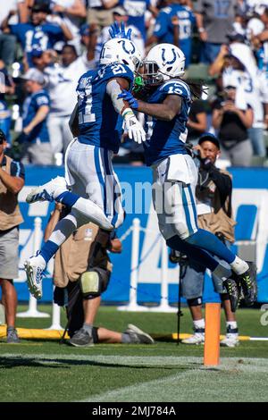 Indianapolis Colts running back Nyheim Hines (21) scores a touchdown ahead  of Tennessee Titans inside linebacker Jayon Brown (55) in the first half of  an NFL football game Thursday, Nov. 12, 2020