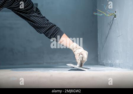 manual application of waterproofing on the floor on the construction site Stock Photo