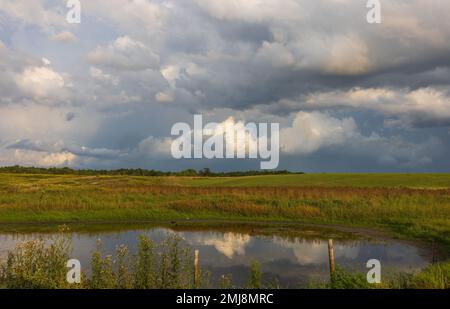 Storm clouds clearing over a farmer's field in northern Wisconsin. Stock Photo