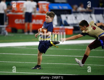 Children involved with Play 60 run onto the field to participate in a game  of flag football during half time of a preseason NFL football game between  the Tampa Bay Buccaneers and