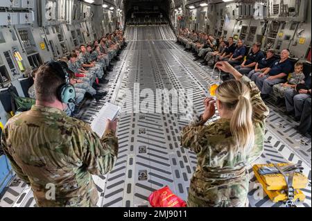 U.S. Air Force Senior Airman Raymie Roberts and Tech. Sgt. Sarah Hall, loadmasters for the 167th Airlift Squadron, brief emergency procedures to Civil Air Patrol cadets before a C-17 Globemaster III aircraft orientation flight, Shepherd Field, Martinsburg, West Virginia, Aug. 25, 2022. About 49 CAP members from West Virginia, Virginia and Maryland participated in the hour-long flight. After the flight, the CAP members spoke with Airmen at the 167th Airlift Wing to learn more about some of the career fields at the Martinsburg air base. Stock Photo