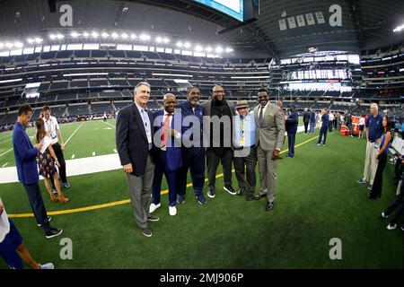 Dallas Cowboys former players Emmitt Smith, left, Troy Aikman, center rear  and Michael Irvin before a halftime ceremony during an NFL football game  against the New York Giants, Sunday, Sept. 20, 2009