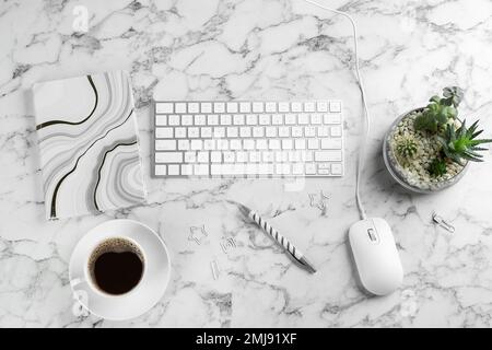 Flat lay composition with mouse and keyboard on white marble table Stock Photo