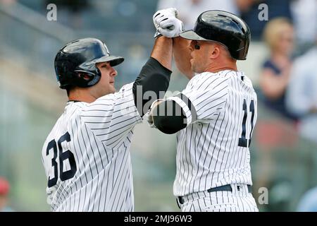 New York Yankees on-deck batter Erik Kratz (38) celebrates with teammate  Thairo Estrada, right, after Estrada hit a solo home run during the fourth  inning of a baseball game, Monday, Aug. 17