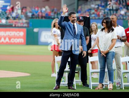 Former Texas Rangers' Michael Young, stands by his wife Cristina