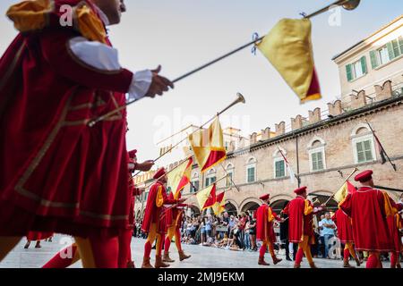 Parade of the medieval Quintana of Ascoli Piceno in Piazza del Popolo is admired every year by a considerable crowd of tourists who crowd civilly in t Stock Photo