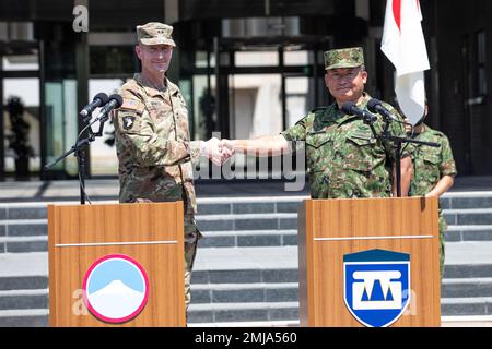The Commanding General of U.S. Army Japan, Maj. Gen. J.B. Vowell, left,  shakes hands with Lt. Gen. Ryoji Takemoto, Commanding General of the Western Army, Japan Ground Self Defense Force, after their remarks at the Orient Shield 22 opening ceremony, Aug. 27, 2022. Orient Shield 22 is the largest U.S. Army and Japan Ground Self-Defense Force bilateral field training exercise being executed in various locations throughout Japan to enhance interoperability and test and refine multi-domain and cross-domain operations. Stock Photo