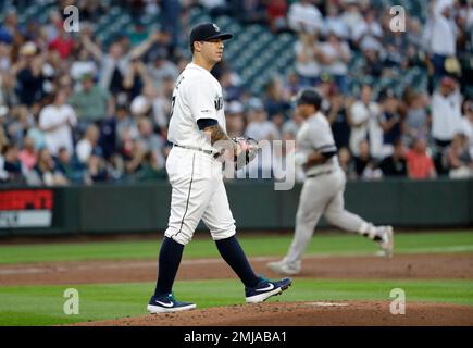 Seattle Mariners' Mike Ford walks through the dugout with a trident after  hitting a solo home run during the ninth inning of a baseball game against  the Los Angeles Angels Friday, June