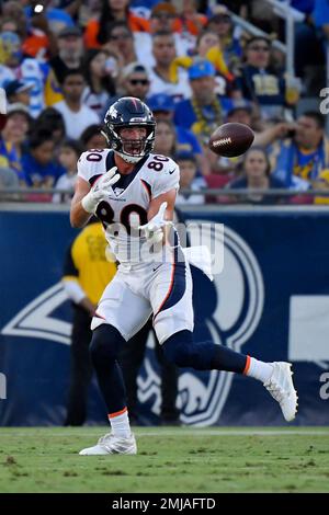 Denver Broncos tight ends coach Jake Moreland chats with tight end Eric  Saubert as he takes part in drills during the NFL football team's training  camp Thursday, Aug. 4, 2022, at the