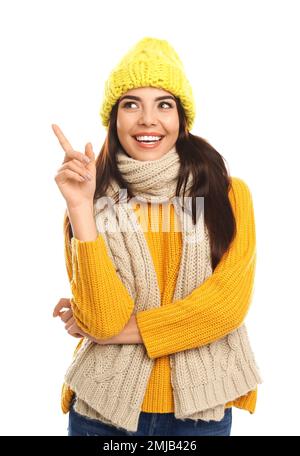 Happy young woman in warm clothes on white background. Winter vacation Stock Photo