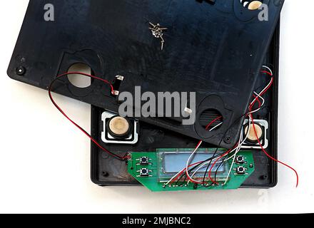 Open electronic device with visible circuit board chips and wires Stock Photo