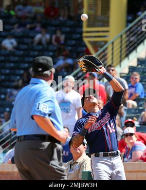 Minnesota Twins' Ehire Adrianza, right, dives back to first under the tag  of Los Angeles Angels first baseman Jared Walsh during the seventh inning  of a baseball game Monday, May 20, 2019