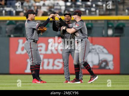 Arizona Diamondbacks' Tim Locastro gets a banana cream pie in the face from  his teammate Adam Jones' son Axel after getting the game winning hit  against the San Diego Padres during the